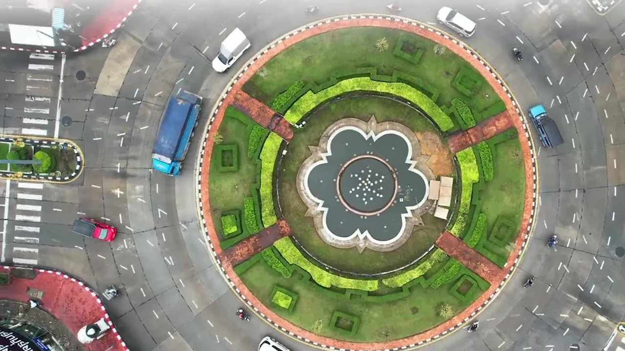 Aerial view of a landscaped traffic roundabout with a symmetrical garden and central fountain, visually representing the interconnected, cross-border nature of Hogan Lovells’ Global Class Actions Hub.